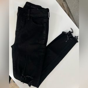 Black distressed American Eagle jean.